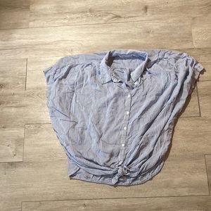 Flowy button down top with tie knot on bottom.